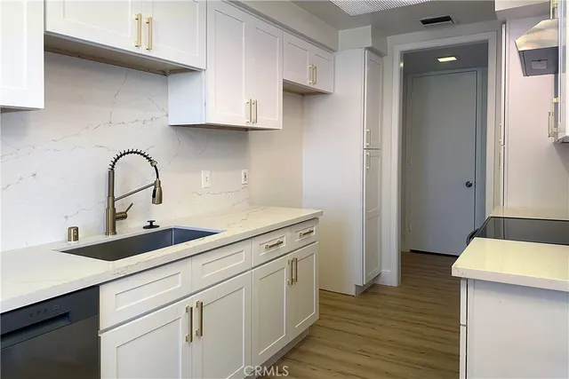 a kitchen with a sink and cabinets