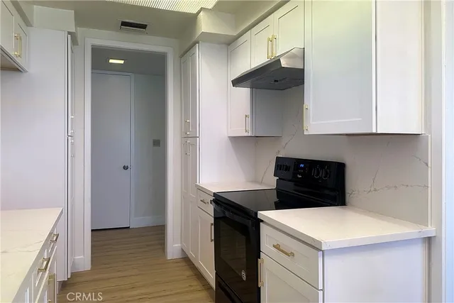 a view of a kitchen with a sink and cabinets