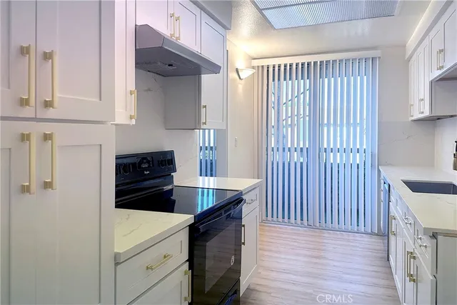a kitchen with stainless steel appliances a refrigerator and a stove