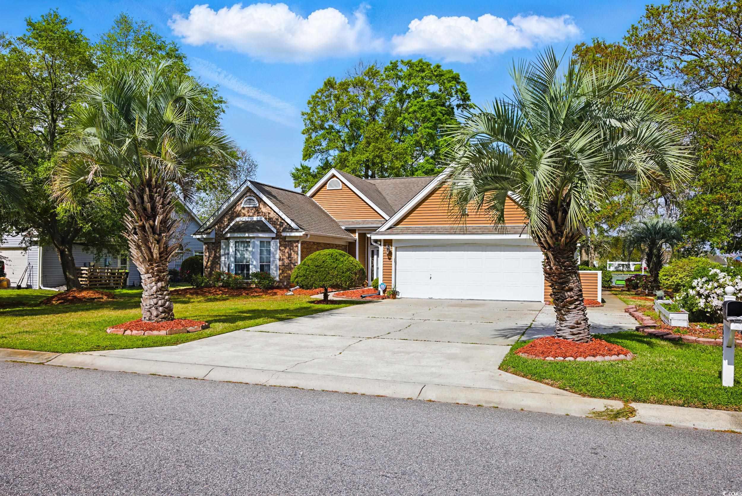 1673 Coventry Road Surfside Beach, SC 29575 - Photo 1 of 30 View of front of home featuring driveway, a garage
