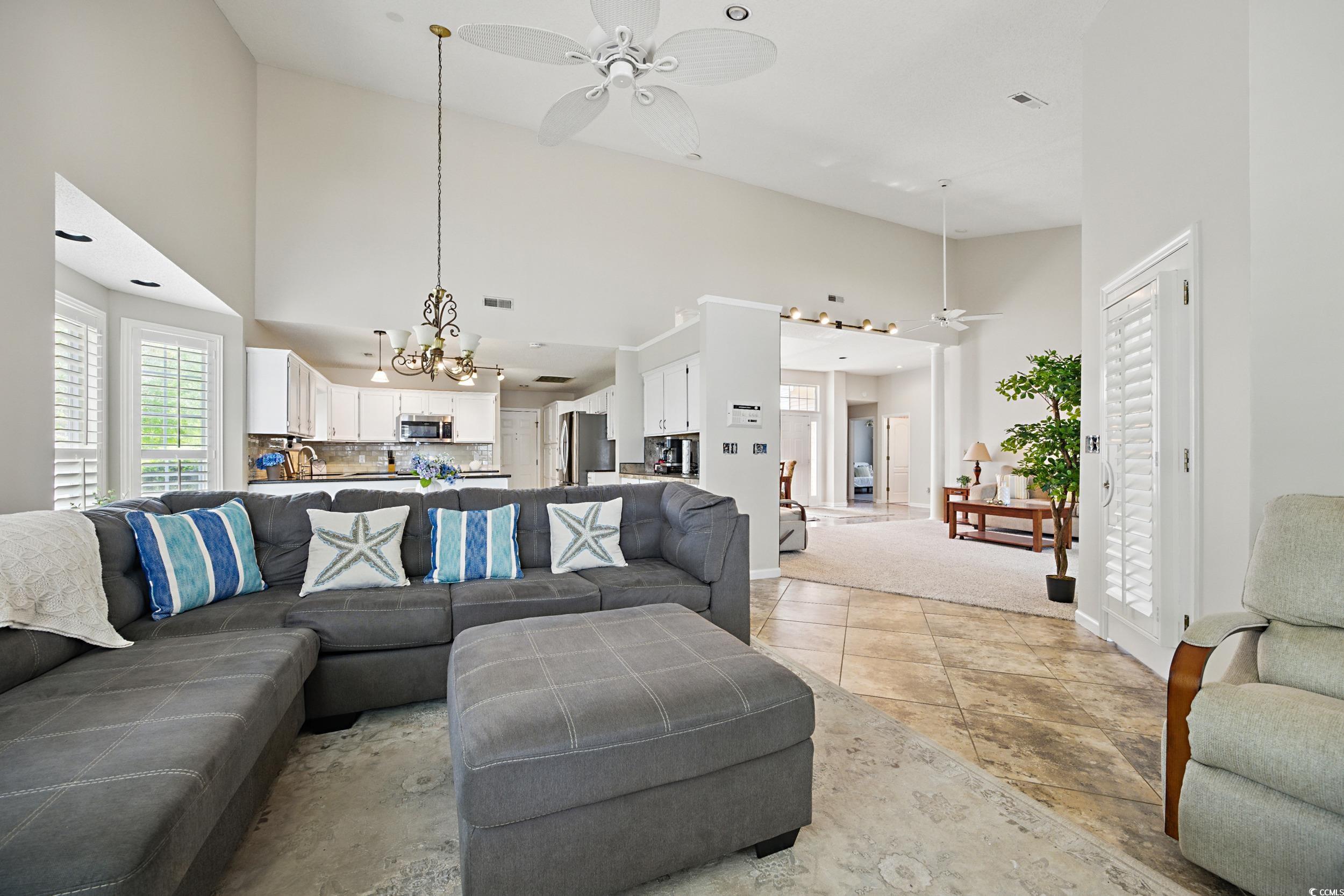 1673 Coventry Road Surfside Beach, SC 29575 - Photo 11 of 30 Living area with ceiling fan with notable chandeli