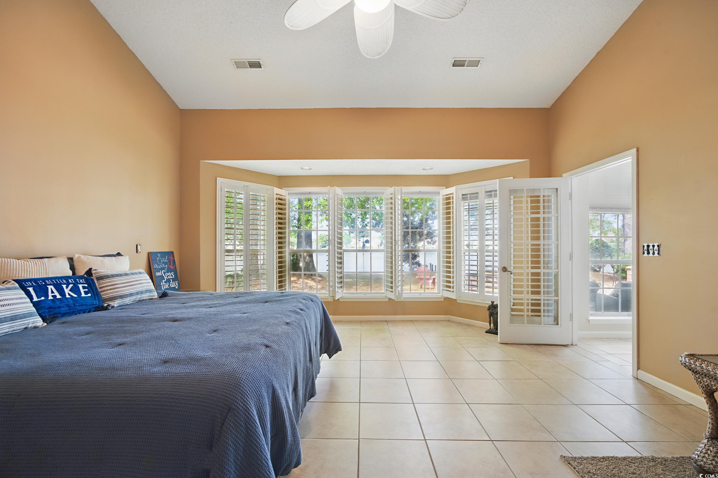1673 Coventry Road Surfside Beach, SC 29575 - Photo 16 of 30 Bedroom with light tile patterned floors, baseboar