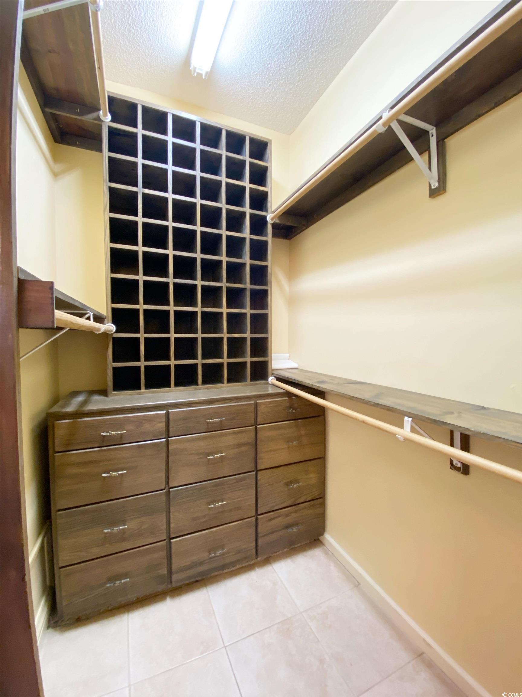 1673 Coventry Road Surfside Beach, SC 29575 - Photo 19 of 30 Walk in closet featuring light tile patterned floo