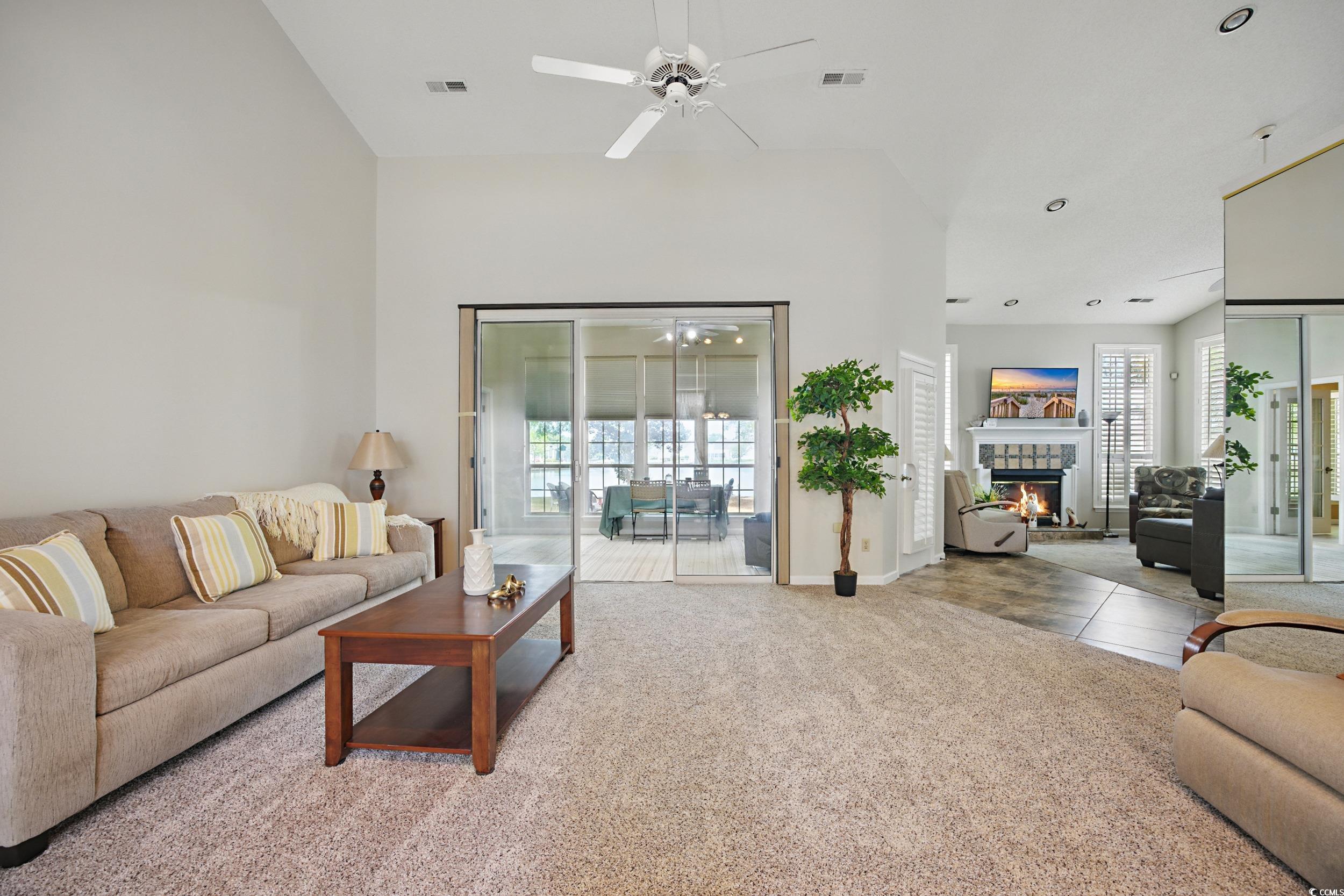 1673 Coventry Road Surfside Beach, SC 29575 - Photo 8 of 30 Carpeted living room featuring a ceiling fan, a he
