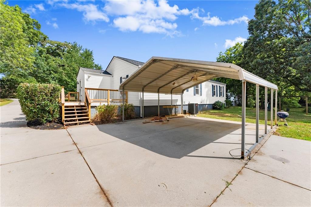 6455 Main Street Lula, GA 30554 - Photo 31 of 43 a view of a patio with a table and chairs under an umbrella