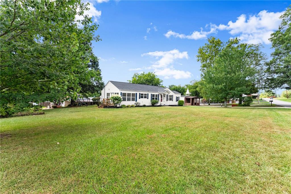 6455 Main Street Lula, GA 30554 - Photo 4 of 43 a view of yard with swimming pool and green space
