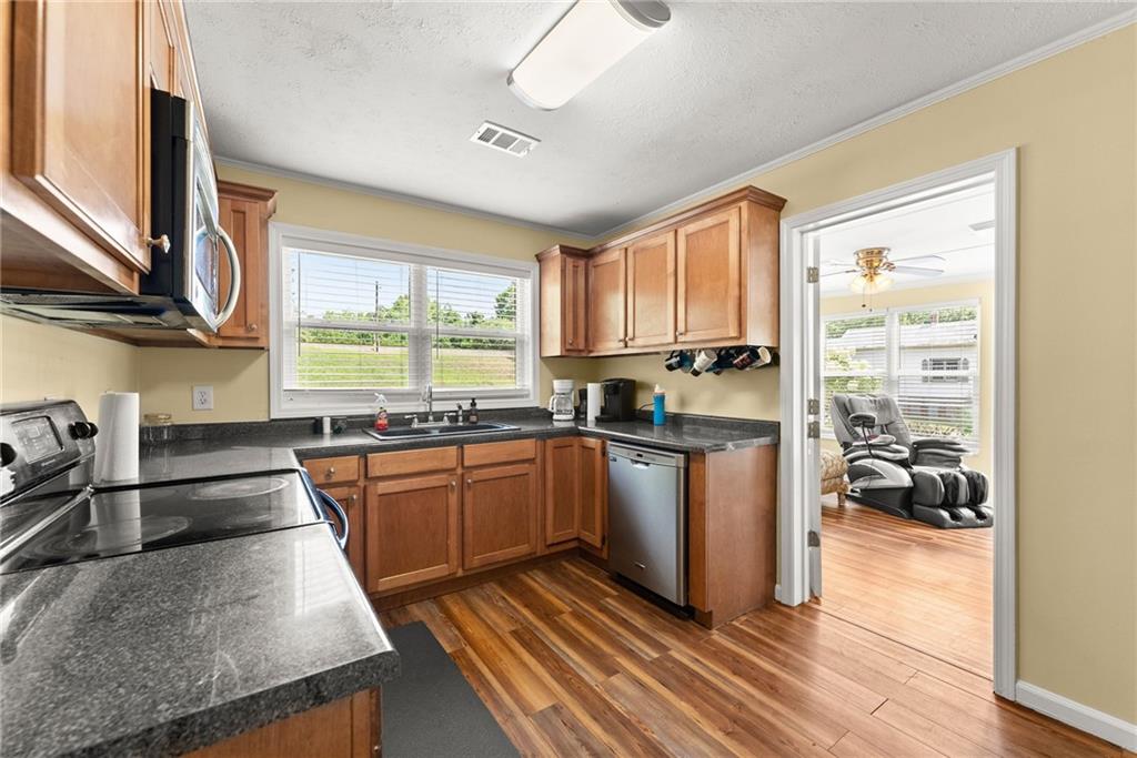 6455 Main Street Lula, GA 30554 - Photo 8 of 43 a kitchen with stainless steel appliances granite countertop a stove a sink and a refrigerator