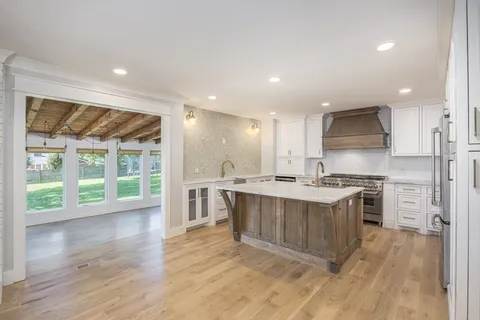 a view of kitchen with wooden floor and electronic appliances
