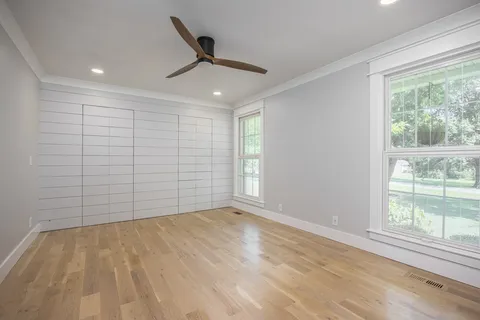 a front view of a house with a garden and plants