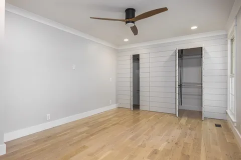 a front view of a house with a garden and plants