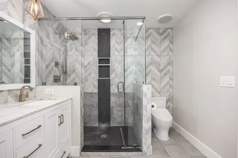 an aerial view of residential houses with outdoor space and trees