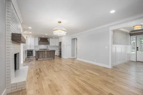 a bathroom with a granite countertop sink and a toilet