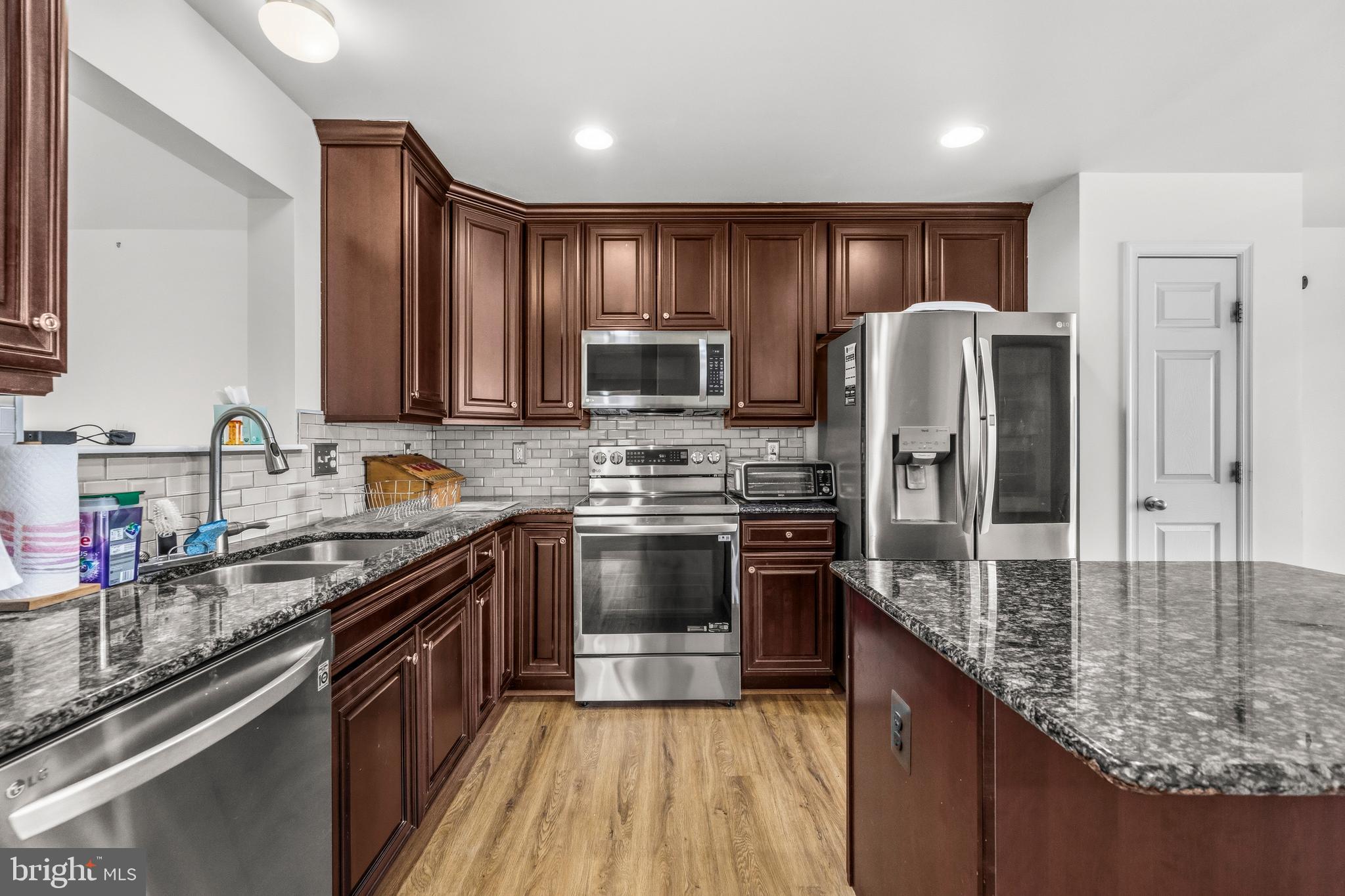 31 Wayside Court Falling Waters, WV 25419 - Photo 11 of 36 a kitchen with stainless steel appliances granite countertop a sink refrigerator and cabinets