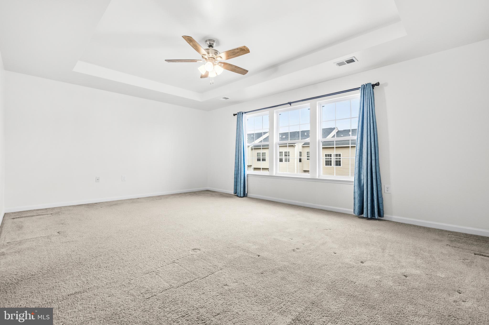 31 Wayside Court Falling Waters, WV 25419 - Photo 19 of 36 an empty room with windows and ceiling fan