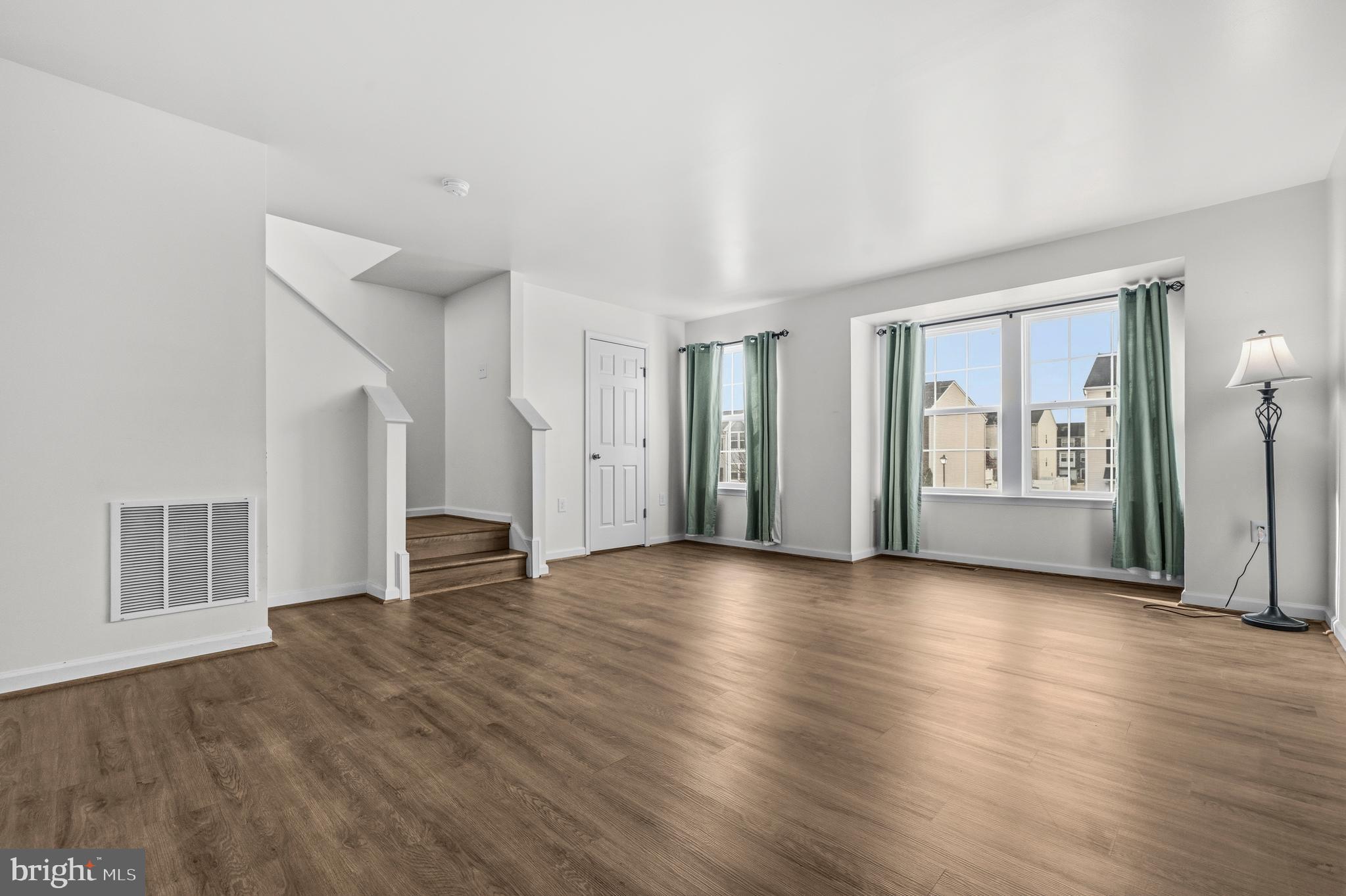 31 Wayside Court Falling Waters, WV 25419 - Photo 2 of 36 a view of an empty room with glass door and wooden floor