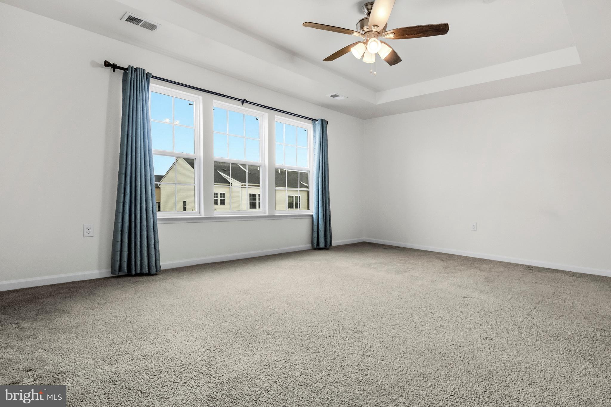 31 Wayside Court Falling Waters, WV 25419 - Photo 21 of 36 an empty room with windows and ceiling fan