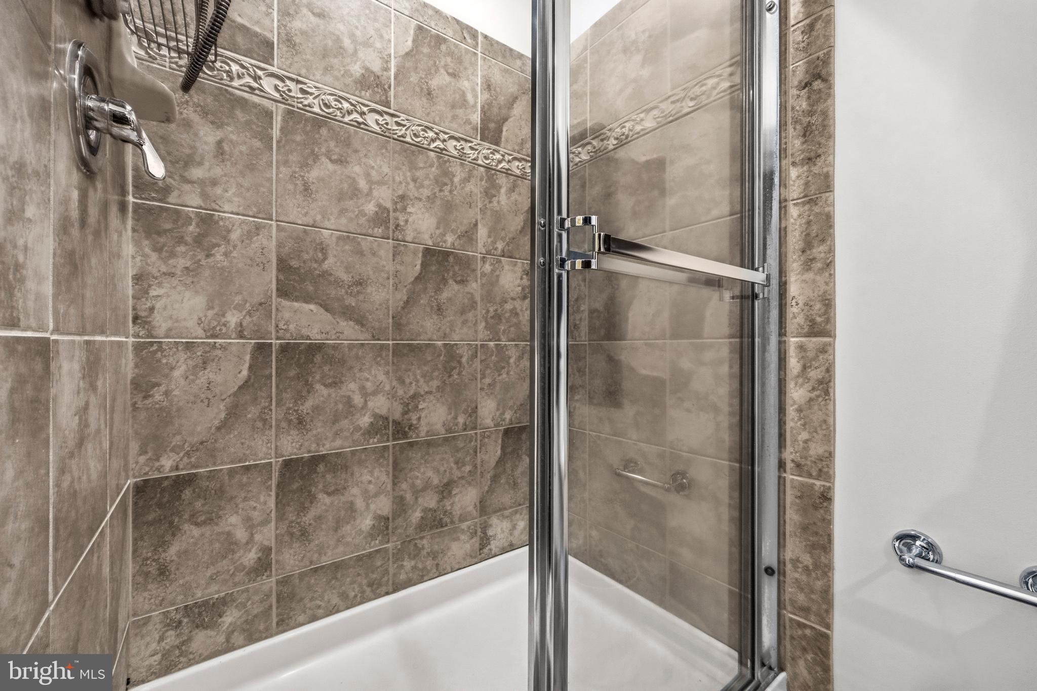 31 Wayside Court Falling Waters, WV 25419 - Photo 24 of 36 a bathroom with a glass shower door