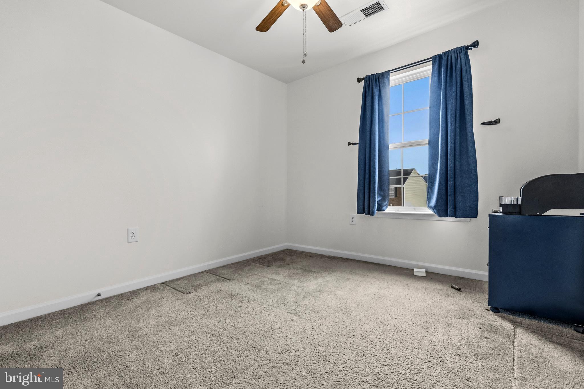 31 Wayside Court Falling Waters, WV 25419 - Photo 25 of 36 an empty room with chandelier fan and windows