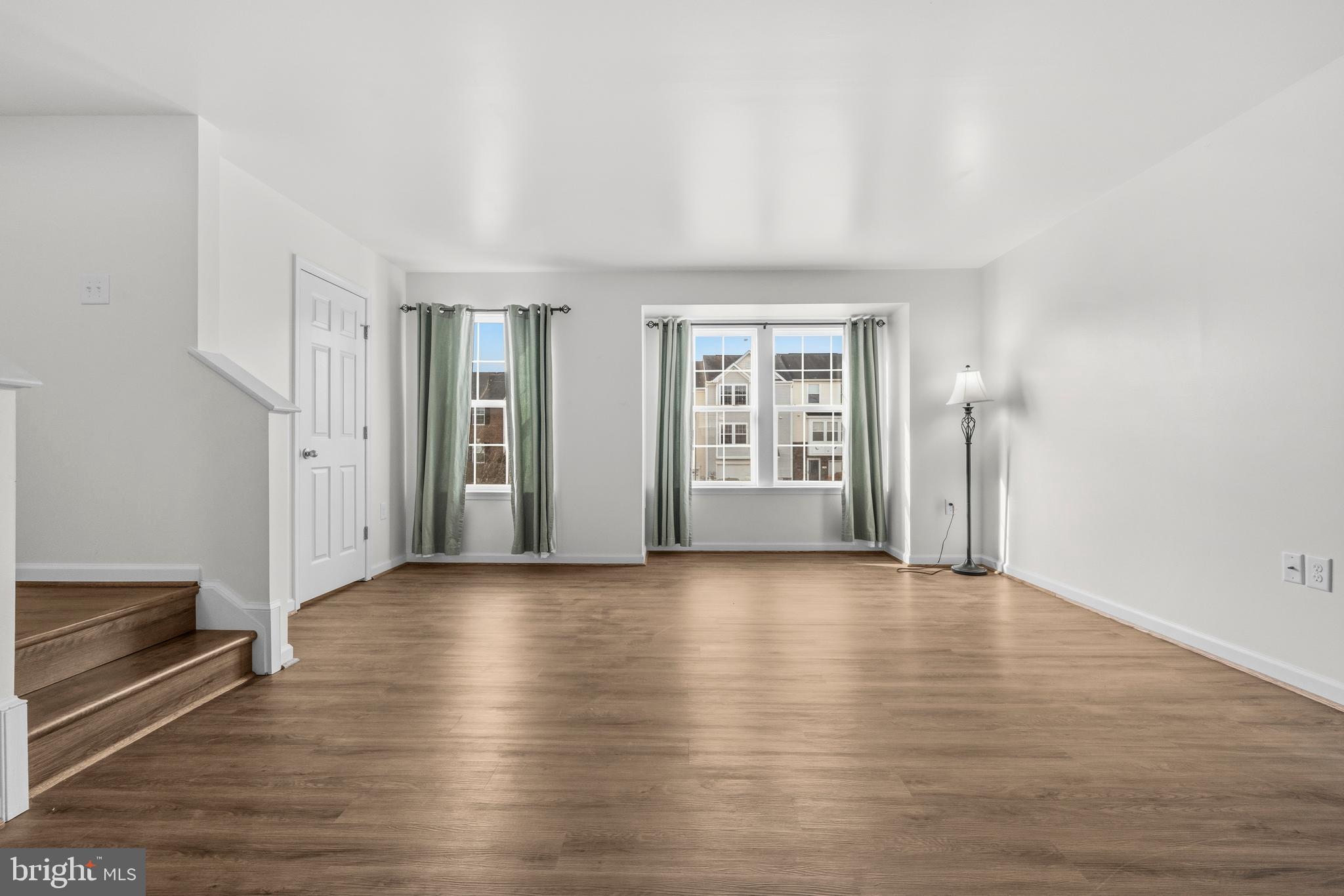 31 Wayside Court Falling Waters, WV 25419 - Photo 3 of 36 an empty room with wooden floor and windows