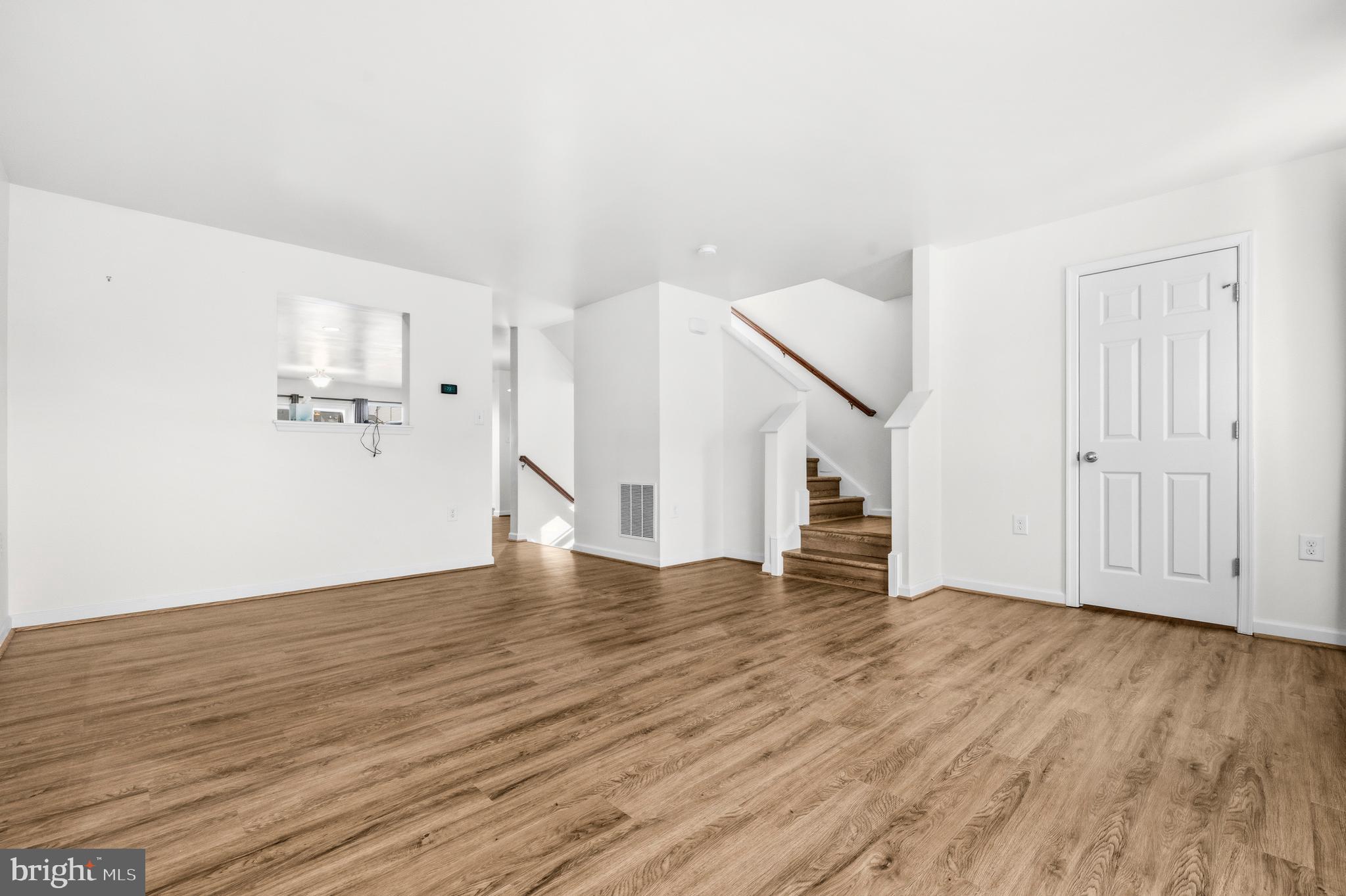 31 Wayside Court Falling Waters, WV 25419 - Photo 5 of 36 an empty room with wooden floor and white walls