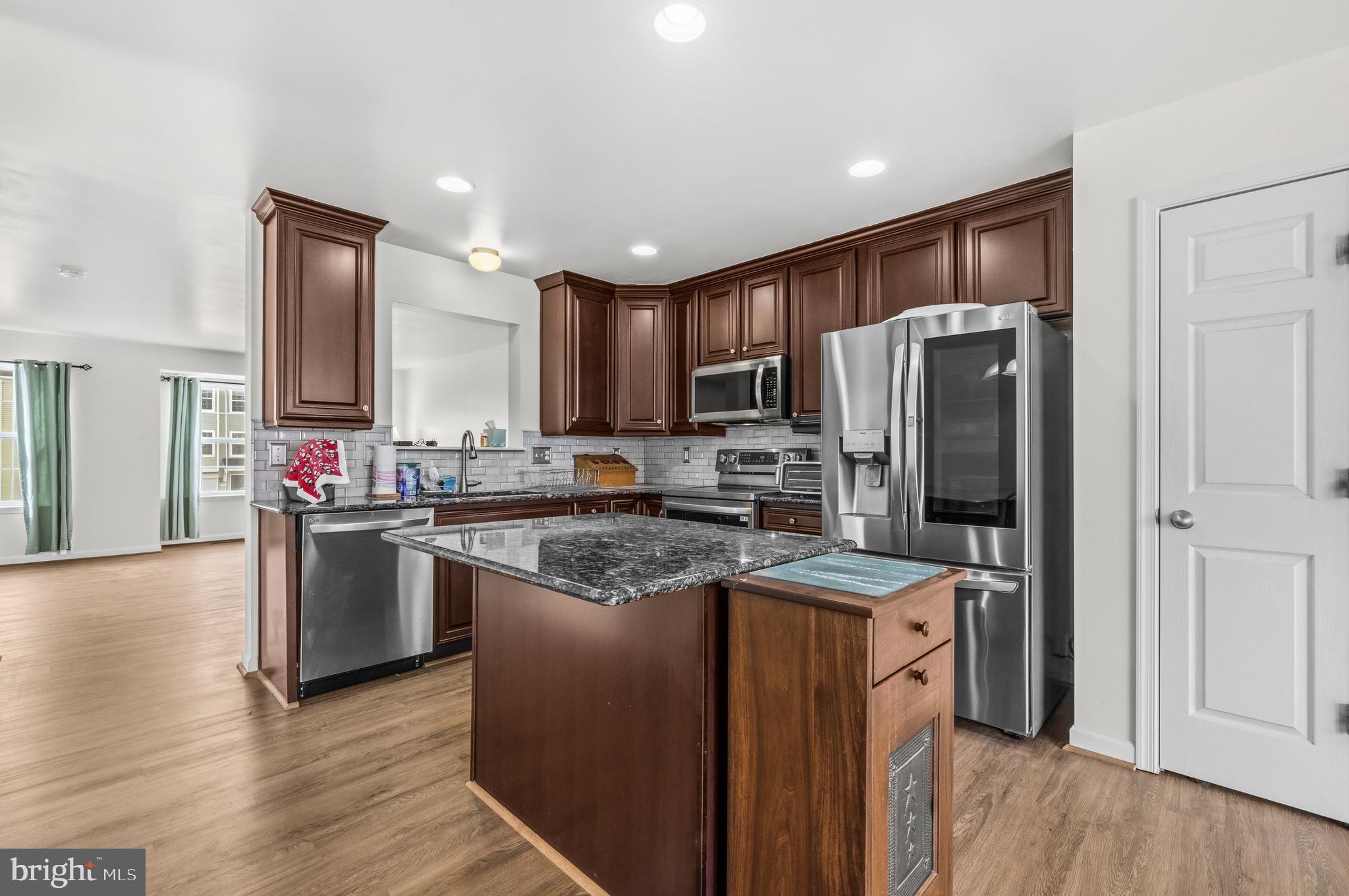 31 Wayside Court Falling Waters, WV 25419 - Photo 8 of 36 a kitchen with stainless steel appliances granite countertop a refrigerator stove and sink