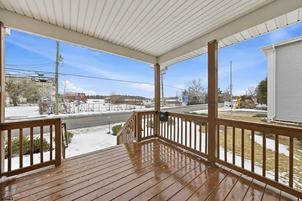 a view of a balcony with wooden floor