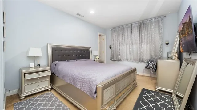 a room with wooden floor pool table furniture and windows