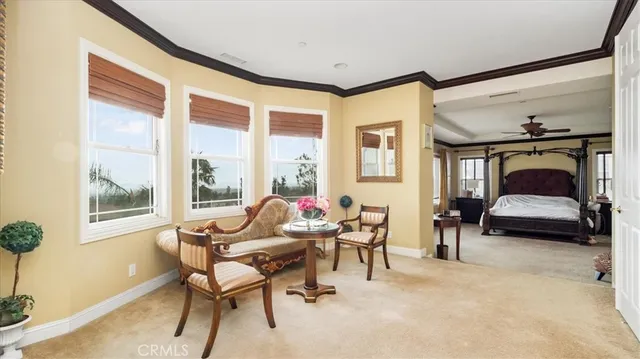 a living room with patio furniture and a floor to ceiling window