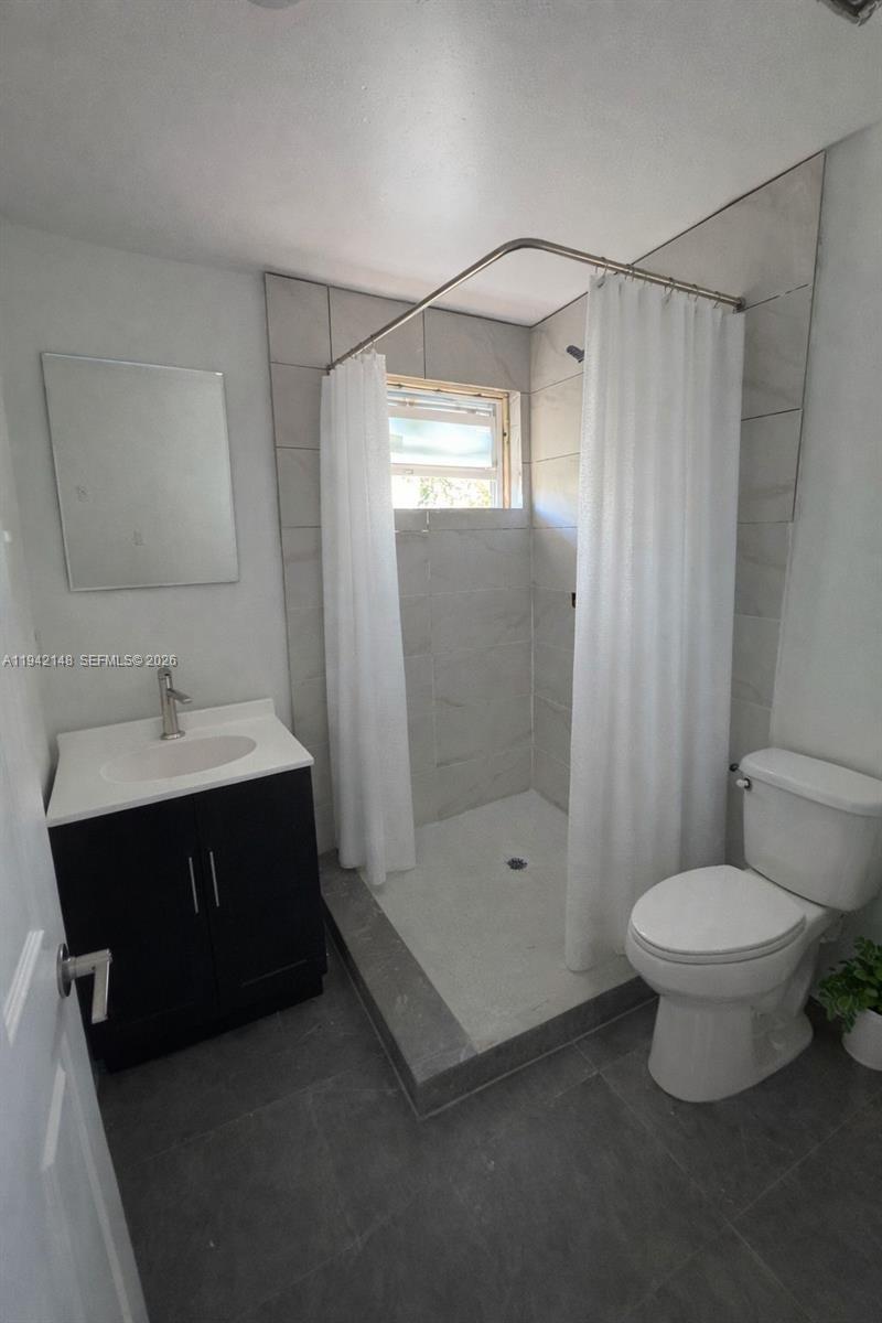 6875 Northwest 4th Avenue, Unit B Miami, FL 33150 - Photo 4 of 5 a bathroom with a sink toilet and shower
