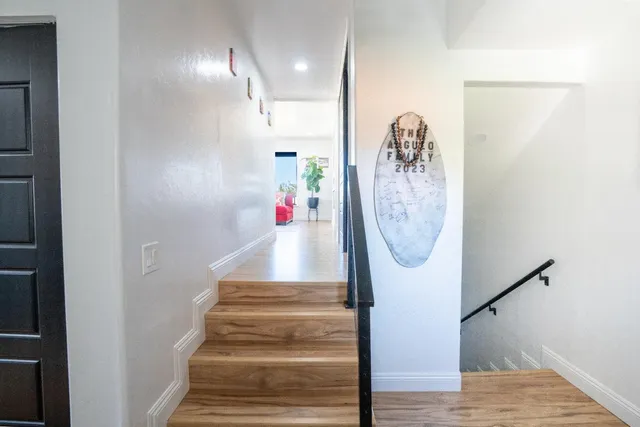 a living room with furniture a flat screen tv and a floor to ceiling window
