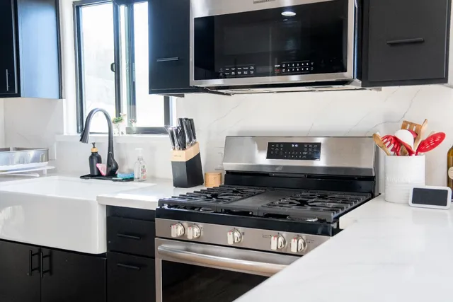 a bedroom with a large bed and a ceiling fan