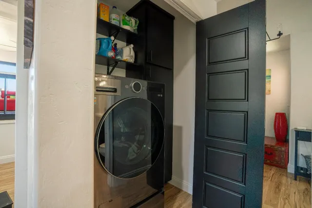 a bedroom with a bed and wooden floor