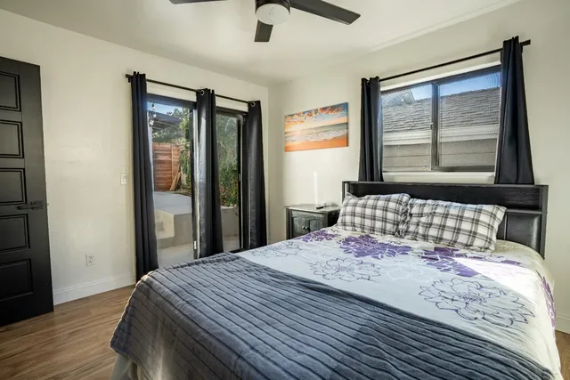 a bedroom with a bed and a painting on the wall