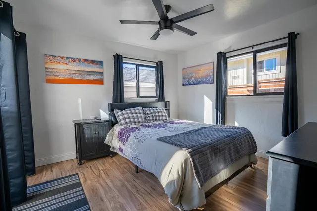 a view of a patio with table and chairs potted plants with wooden floor and fence