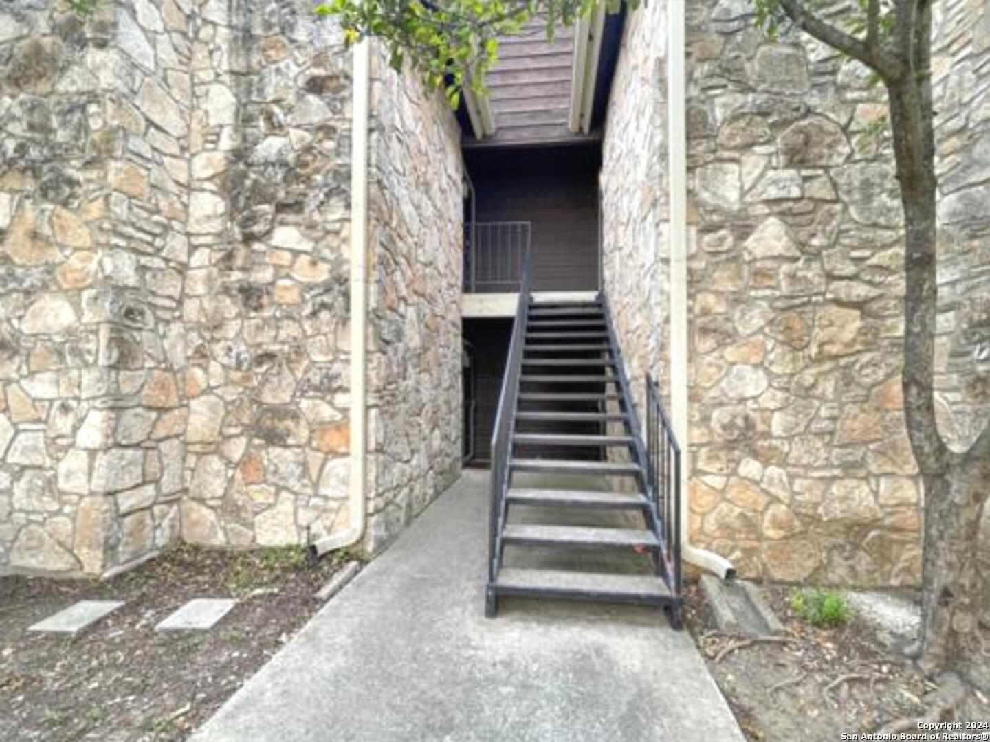 11520 Huebner Road, Unit 107 San Antonio, TX 78230 - Photo 4 of 22 a view of an entryway with stairs