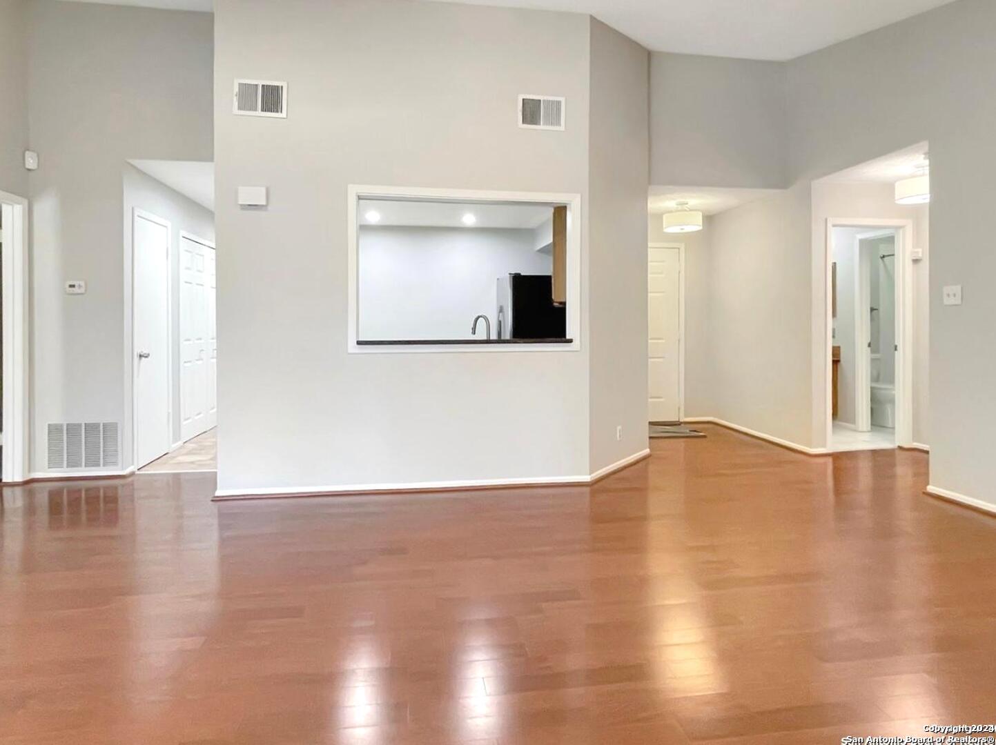 11520 Huebner Road, Unit 107 San Antonio, TX 78230 - Photo 9 of 22 a view of empty room with wooden floor