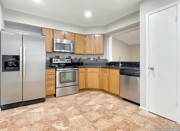 a view of a kitchen with a sink and cabinets