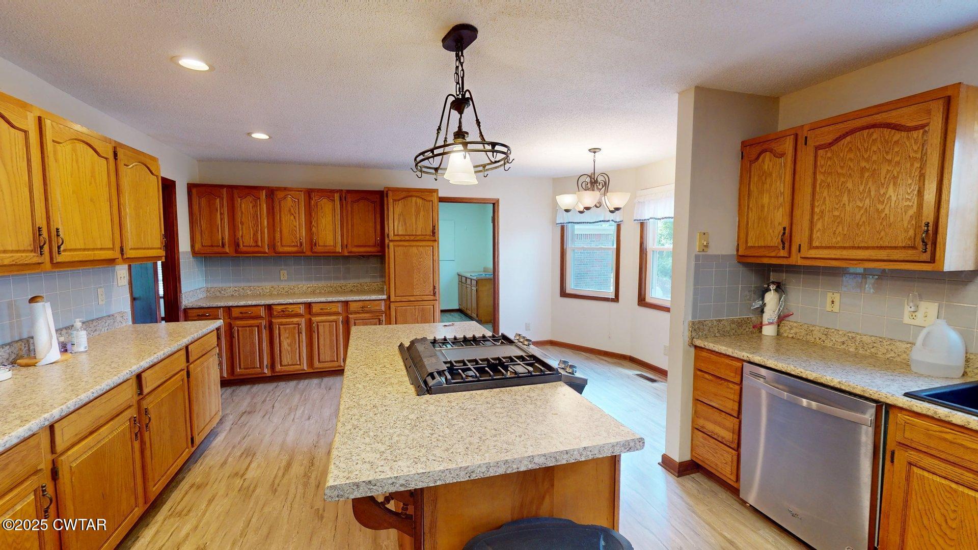 1921 Forrester Road Newbern, TN 38059 - Photo 4 of 18 a kitchen with stainless steel appliances granite countertop a sink stove and refrigerator