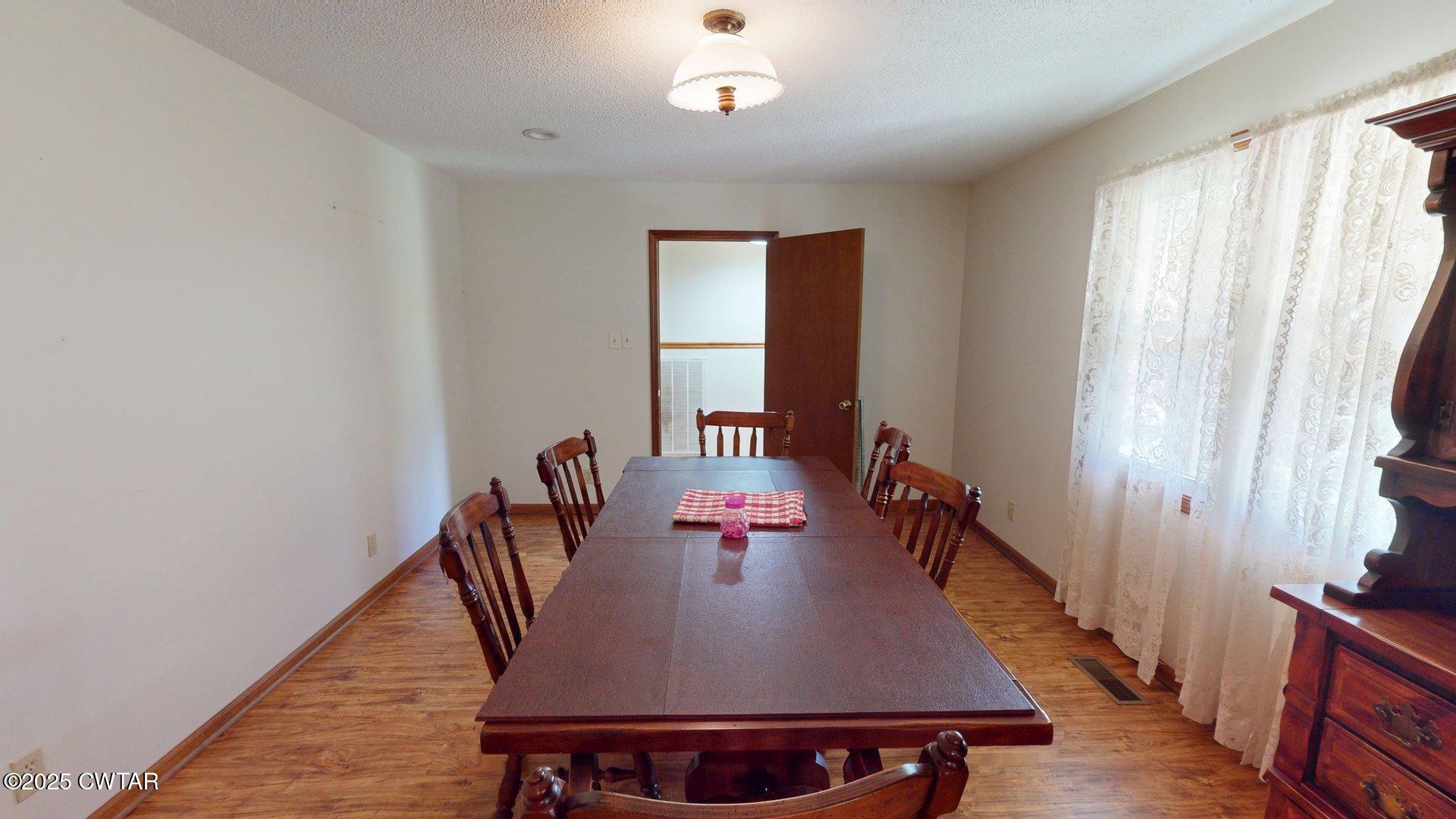 1921 Forrester Road Newbern, TN 38059 - Photo 7 of 18 a view of a dining room with furniture and window