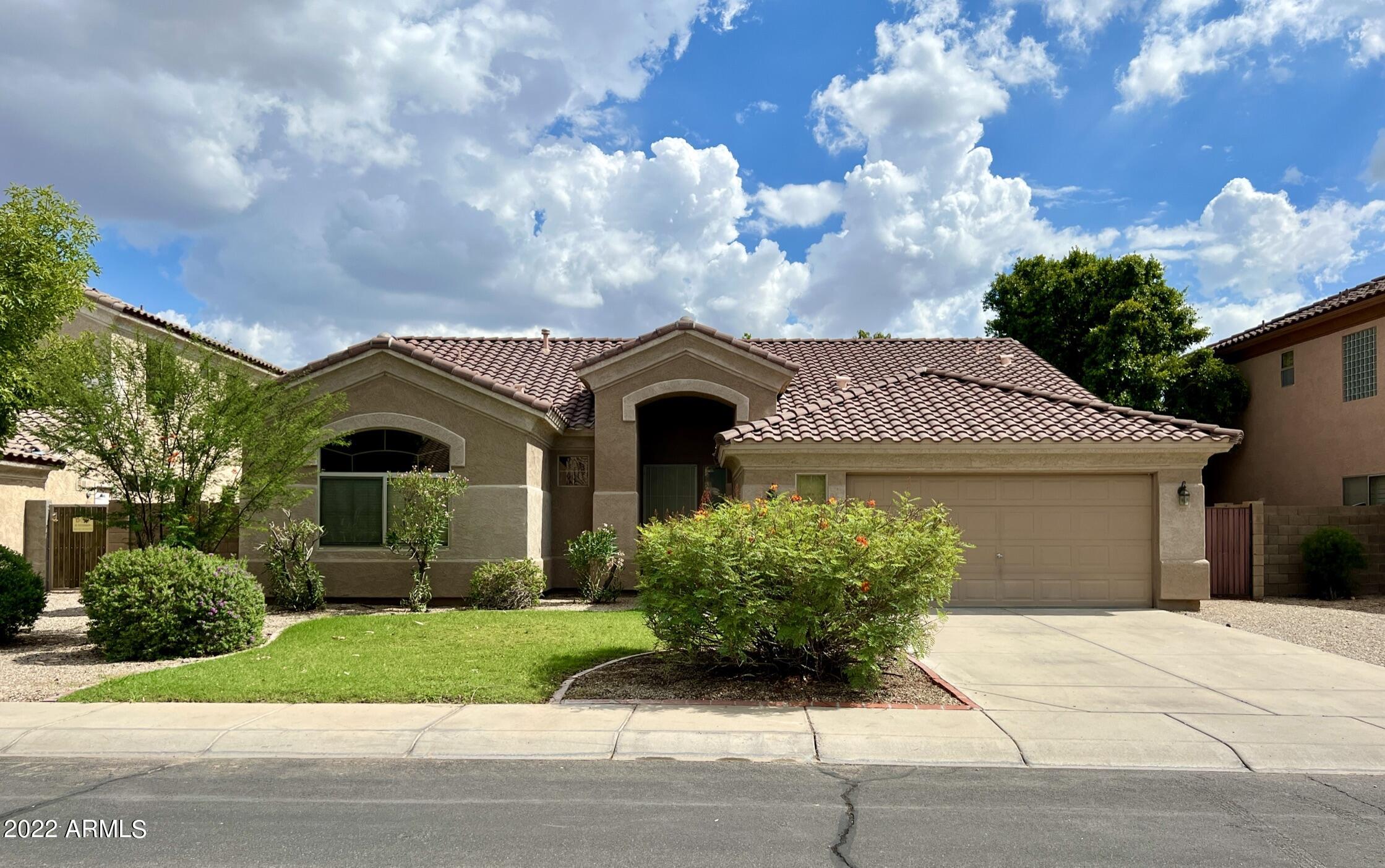 299 West Merrill Avenue Gilbert, AZ 85233 - Photo 1 of 18 a front view of a house with garden
