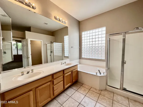 a bathroom with a granite countertop sink mirror and bathtub