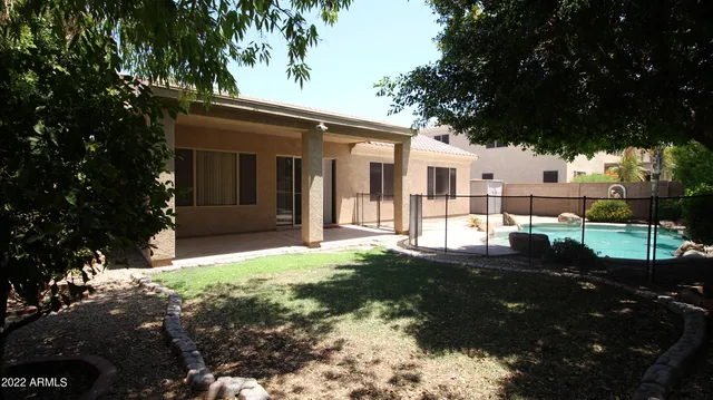 a view of a house with a backyard