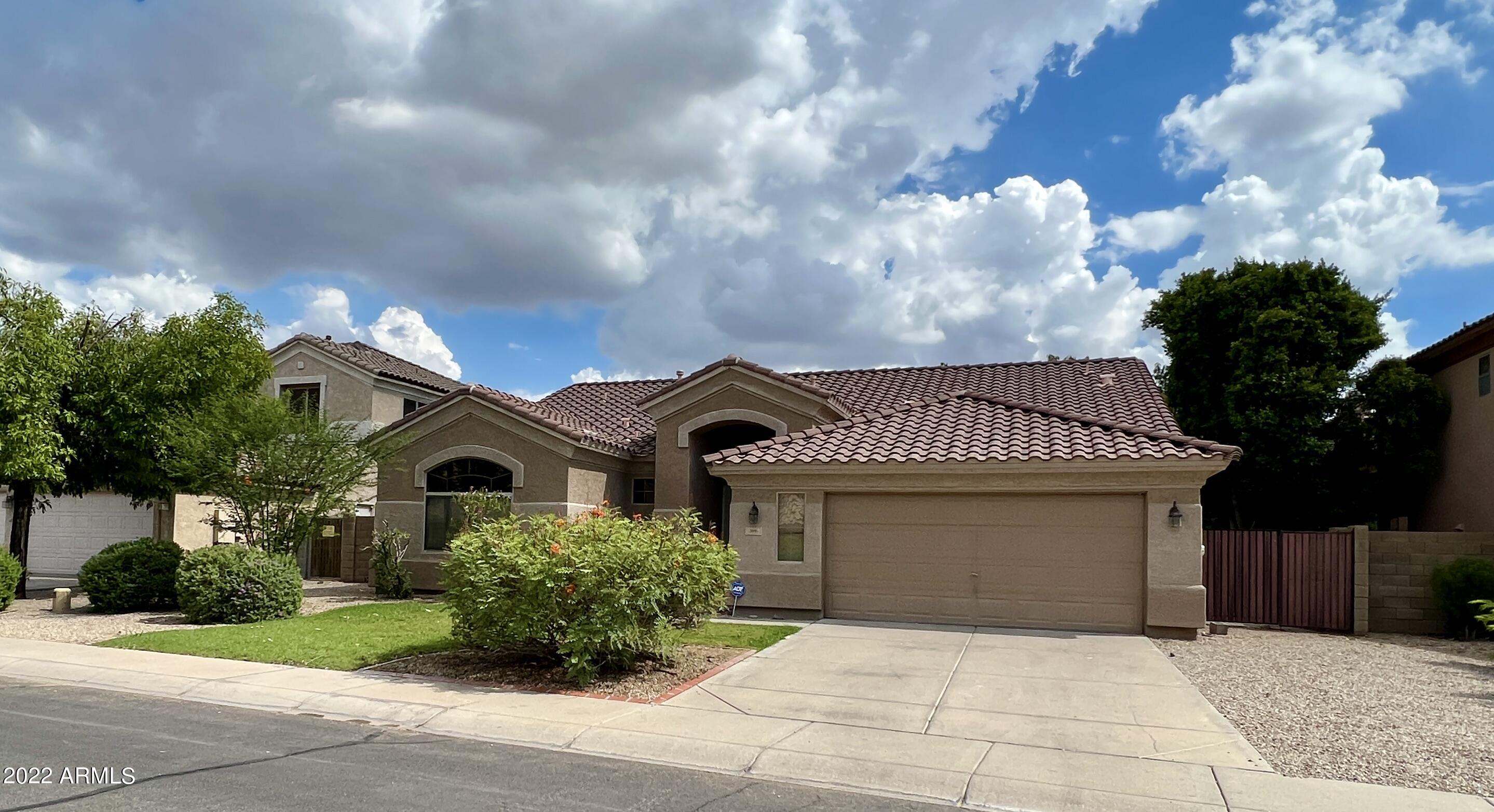 299 West Merrill Avenue Gilbert, AZ 85233 - Photo 2 of 18 a front view of a house with garden
