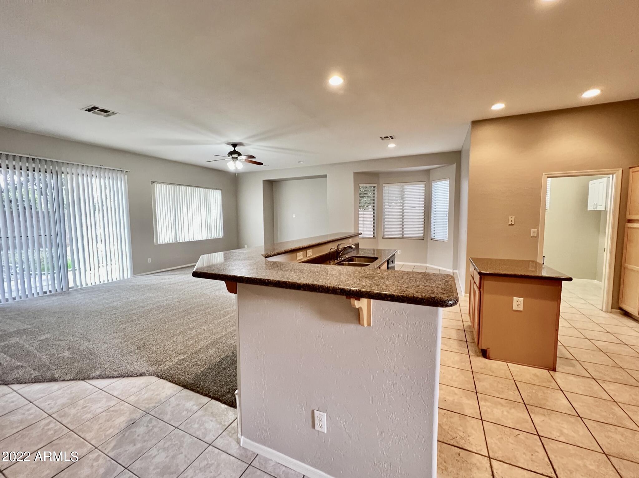299 West Merrill Avenue Gilbert, AZ 85233 - Photo 6 of 18 a kitchen with granite countertop a sink and a stove