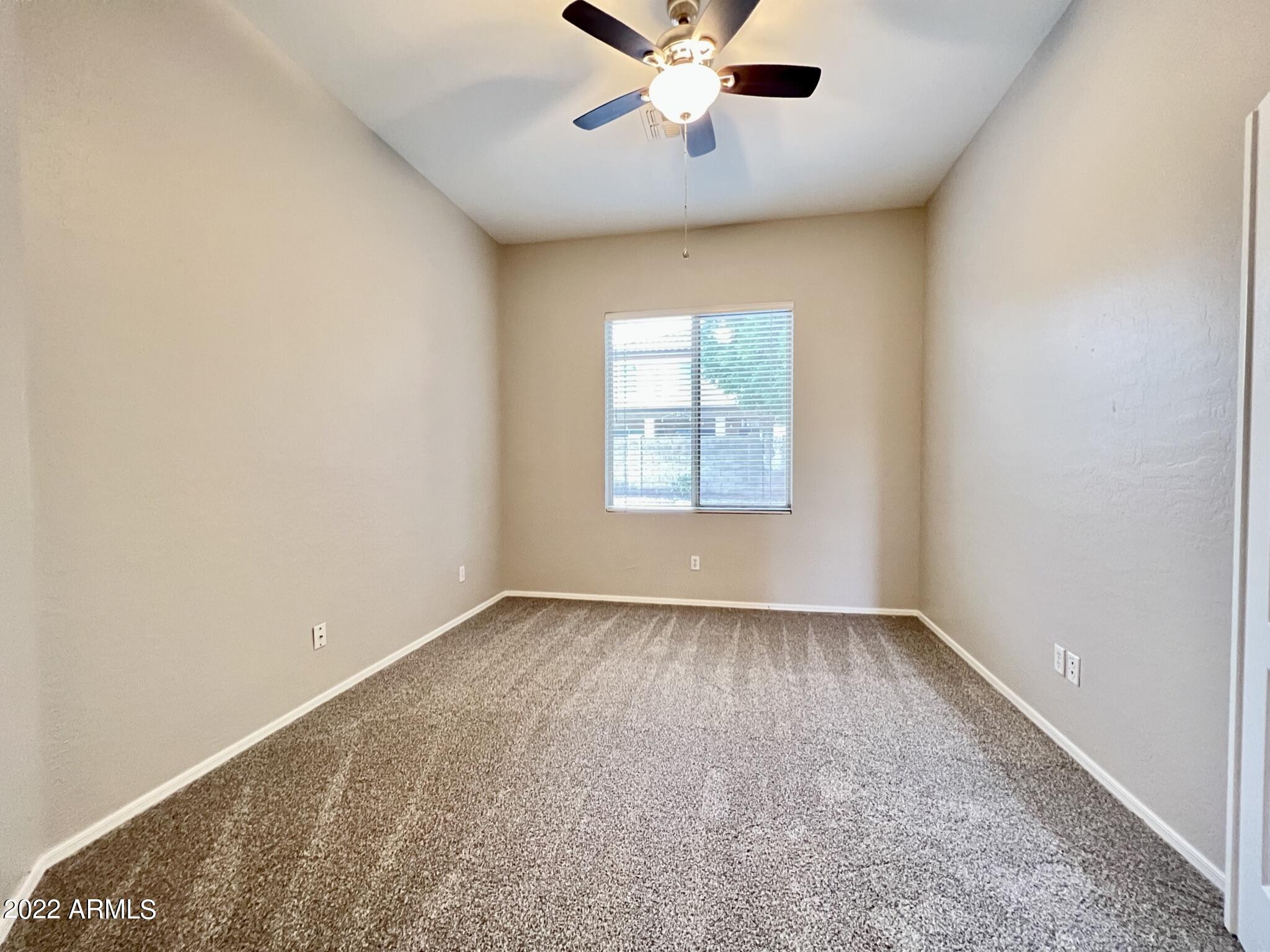 299 West Merrill Avenue Gilbert, AZ 85233 - Photo 10 of 18 an empty room with windows and fan