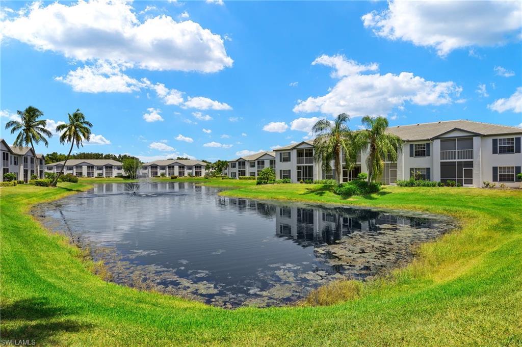 824 Tanbark Drive, Unit 104 Naples, FL 34108 - Photo 11 of 17 a view of a lake with a house in the background