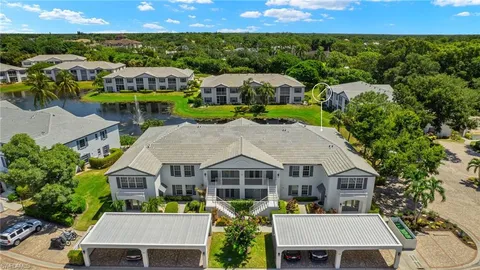 an aerial view of multiple houses with a yard