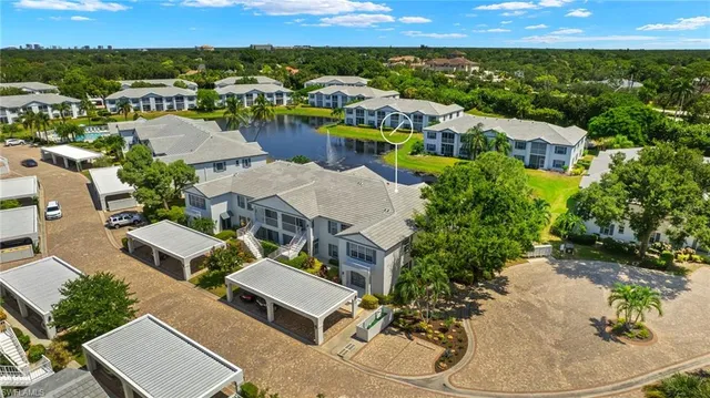 an aerial view of a house with a yard and lake view