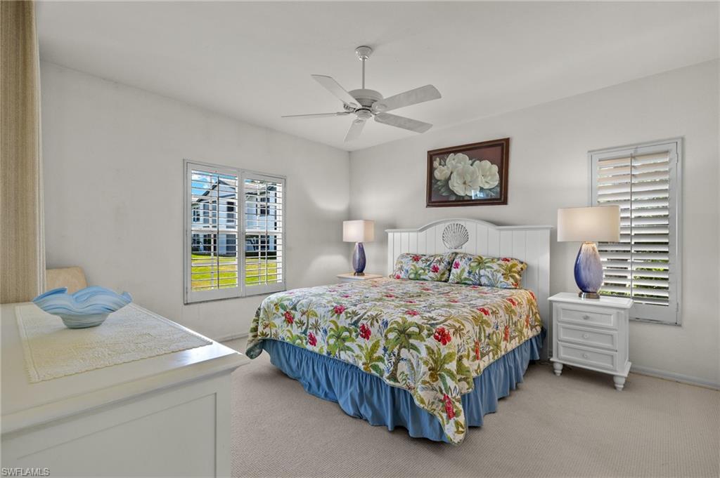 824 Tanbark Drive, Unit 104 Naples, FL 34108 - Photo 6 of 17 a bedroom with a bed and a window