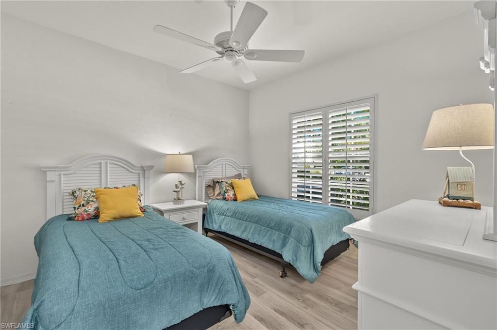 824 Tanbark Drive, Unit 104 Naples, FL 34108 - Photo 7 of 17 a bedroom with two beds and painting on the wall